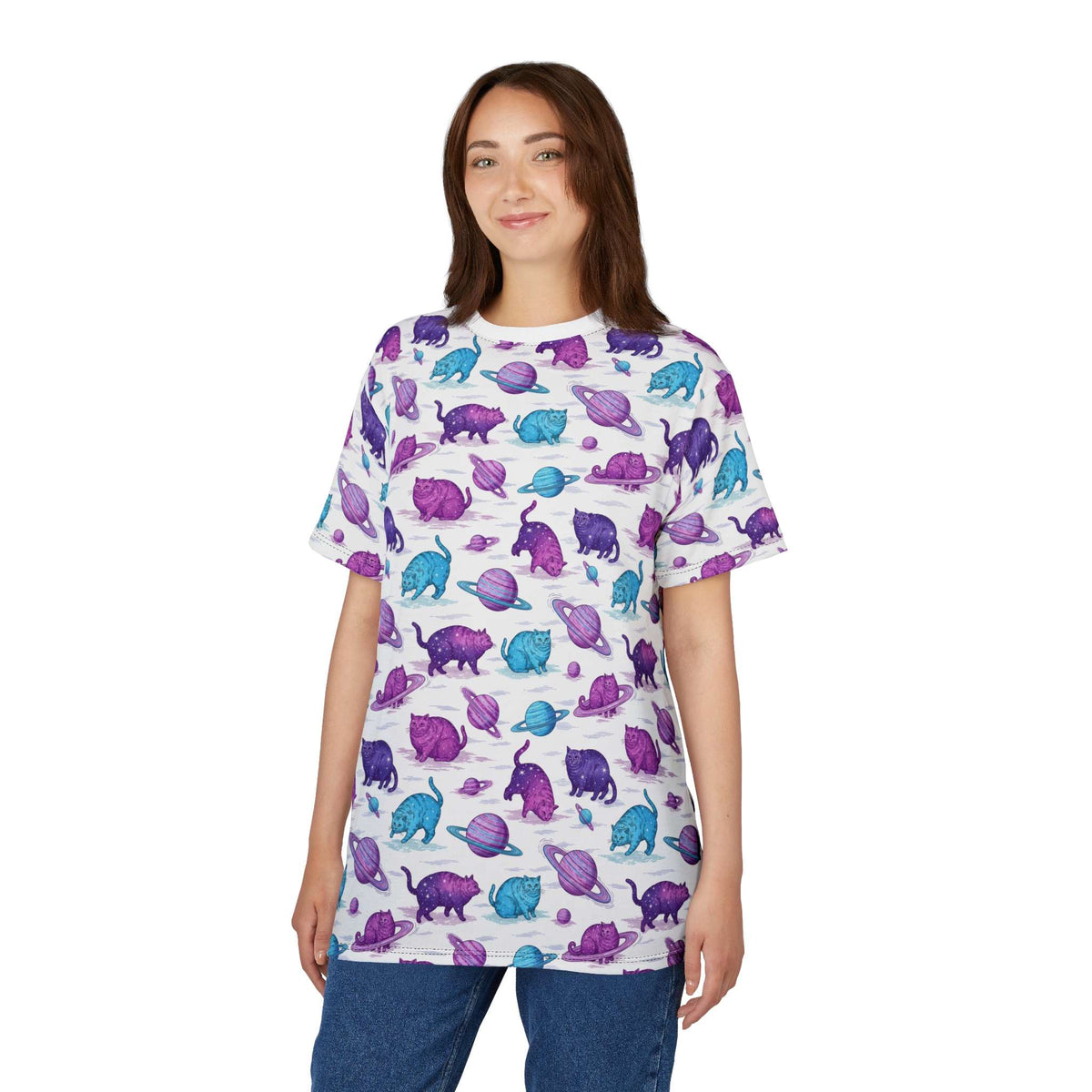 A woman modeling a white short-sleeve t-shirt with an all-over print of purple and blue dinosaur figures, paired with blue jeans, against a plain white background. Artistic Chubby Cats Orbiting Planets Graphic T-Shirt for Casual Wear