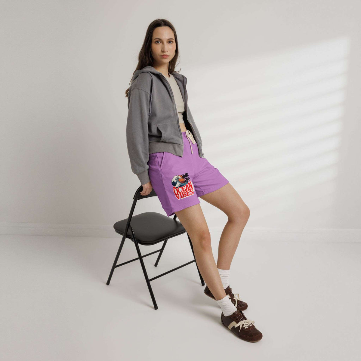 Person wearing a gray hoodie and purple shorts with a colorful design, standing on a white background. Unique Lightweight Fleece Sweat Shorts in Ocean Vibes Graphic Shop Lightweight Fleece Sweat Shorts in Ocean Vibes for breezy comfort, relaxed style, and an easygoing summer-ready look all day. Refresh your casual rotation with Lightweight Fleece Sweat Shorts in Ocean Vibes—soft, versatile, and ready for sunny days by the shore. Buy Lightweight Fleece Sweat Shorts in Ocean Vibes, made for soft comfort.