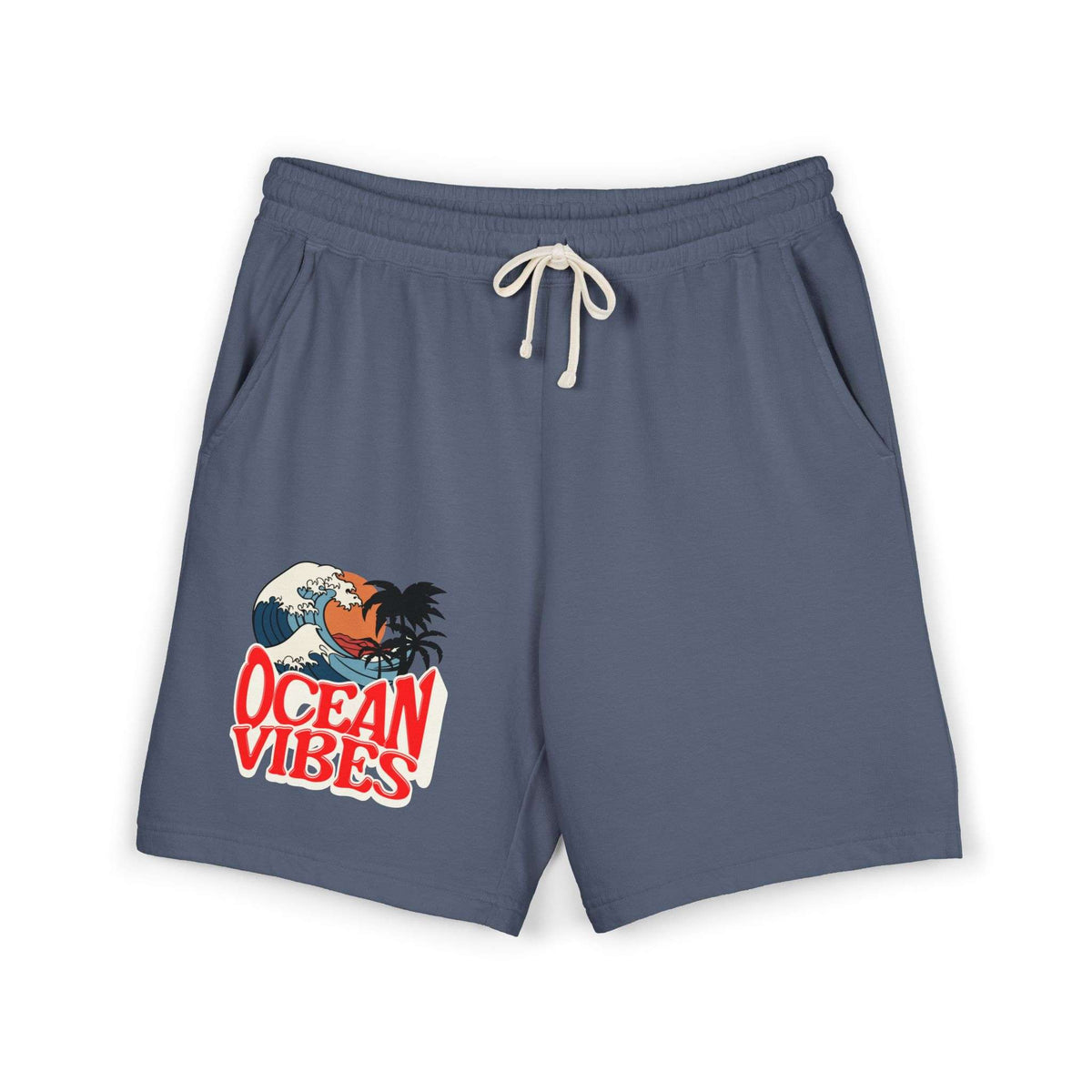 A pair of slate blue drawstring shorts with a 'Ocean Vibes' graphic on the left leg, featuring a cartoon crab and wave design, shown on a plain white background.