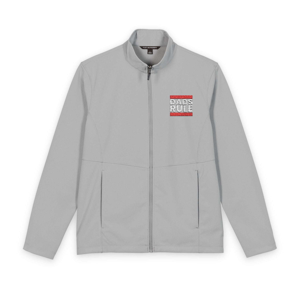 A light gray zip-up jacket with a stand collar, featuring a small red and white graphic on the left chest that reads 'BADS RULE'. The jacket is displayed flat against a clean white background.