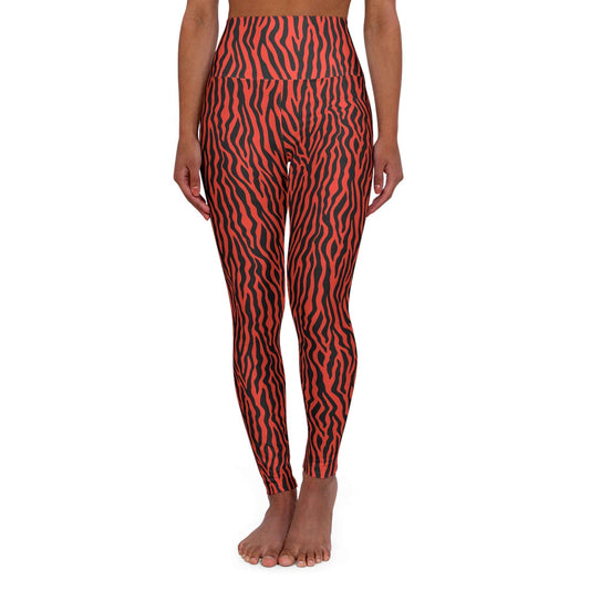 A model from the waist down wearing high-waisted leggings with a bold red and black wavy animal print pattern, standing barefoot against a plain white background. Comfortable Bold Red Zebra Stripes High-Waist Yoga Leggings