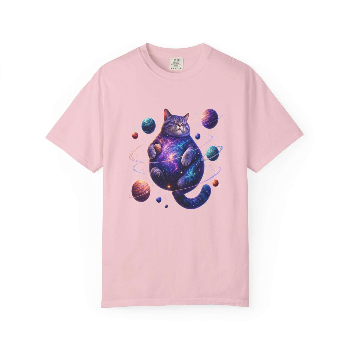 A light pink short-sleeve crewneck t-shirt featuring a colorful graphic of a cosmic, galaxy-patterned cat surrounded by planets, displayed on a clean white background. Comfortable Celestial Feline: Space-Themed Cat T-Shirt for Casual Wear