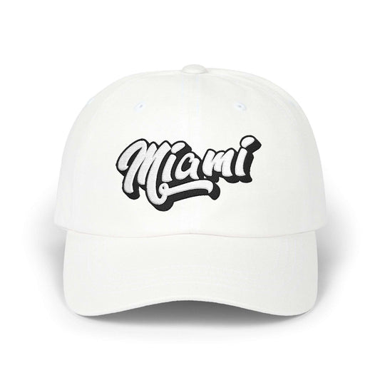 A white baseball cap featuring the word 'Miami' embroidered in a stylized black and white cursive font on the front, set against a clean white background. Minimalist Miami Beach Typography Classic Dad Cap