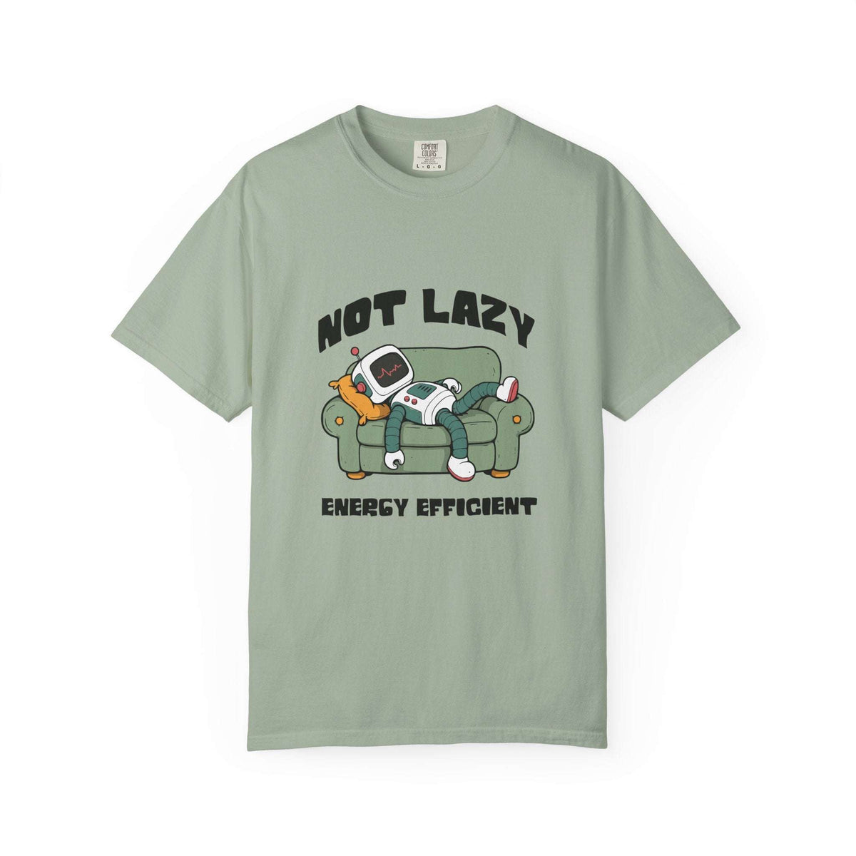 A sage green short-sleeve t-shirt with a cartoon graphic of a person lounging on a couch with a retro computer, accompanied by the text 'NOT LAZY ENERGY EFFICIENT'.