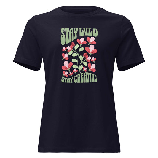 A navy blue short-sleeve t-shirt with a retro graphic on the chest featuring pink and red flowers, green leaves, and the text 'STAY WILD' and 'STAY CREATIVE' in a light green retro font, shown against a plain white background. Stay Wild Stay Creative Women's Relaxed T-Shirt Casual Wear
