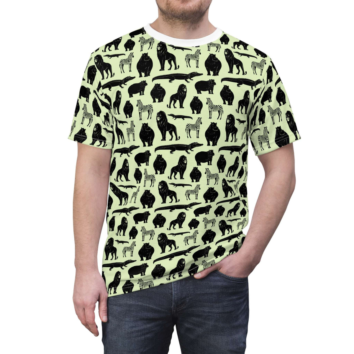 A man wearing a short-sleeve crewneck t-shirt with an all-over animal silhouette print. The shirt features black and gray silhouettes of gorillas, zebras, and crocodiles on a pale yellow-green background. Trendy Bold Jungle Safari Animal Pattern T-Shirt for Casual Wear